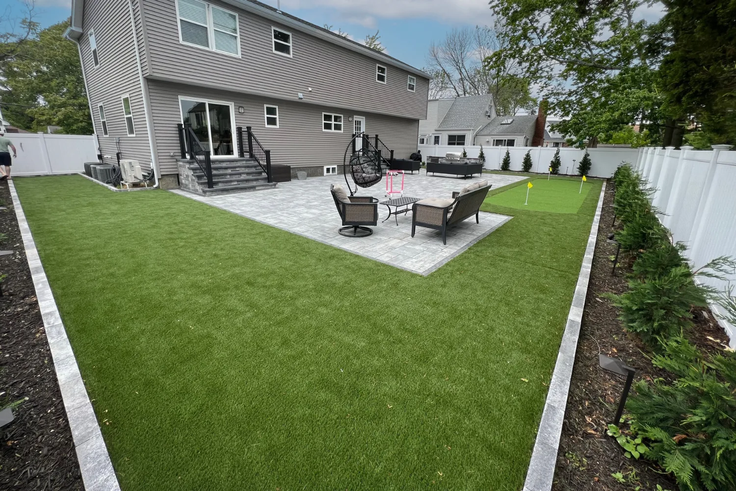 Artificial turf lawn with backyard putting green in San Angelo, TX
